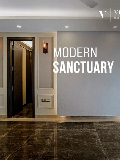 A modern sanctuary begins with a strong architectural base. The dark marble flooring and textured gray wall with classic molding create a dramatic yet sophisticated backdrop for this living space.