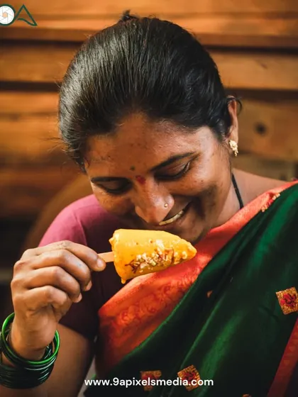 A heartwarming lifestyle shot of a woman enjoying a homemade mango kulfi, capturing a moment of pure, simple joy.