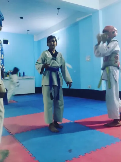 A moment of instruction between rounds during a practice match at the Tiger Taekwondo Academy.