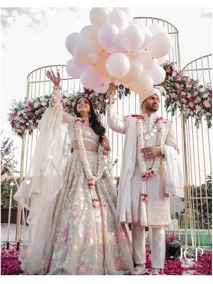 A joyful moment with the couple releasing balloons after their wedding ceremony.