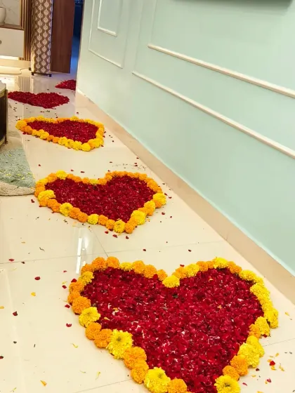 A path of love for a little princess. These heart-shaped arrangements made from fresh red and yellow flower petals create a stunning and traditional walkway for the baby's first steps into her new home.