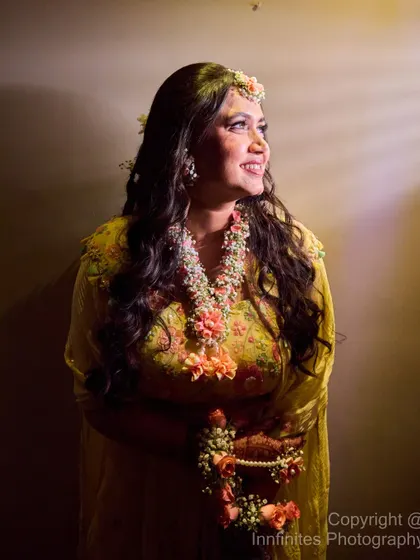 I used dramatic side-lighting to create this beautiful, glowing portrait of the bride during her Haldi. It highlights her smile and the festive atmosphere.