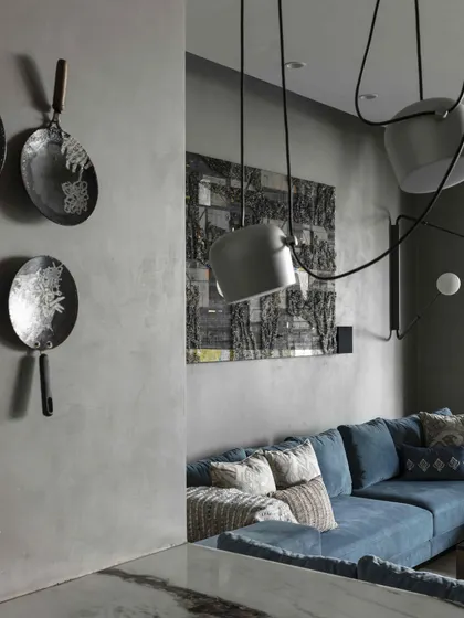The first-floor family lounge is a cozy retreat featuring art by Kaushik Saha and a whimsical piece by Samanta Batra Mehta. A stunning Flos light installation hangs above the breakfast counter, blending art with function.