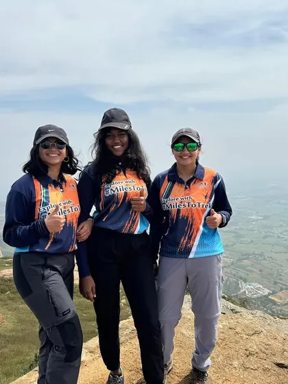Three women from our 'Mom & Me' trek posing at the summit. We empower women and children to explore the outdoors with confidence.
