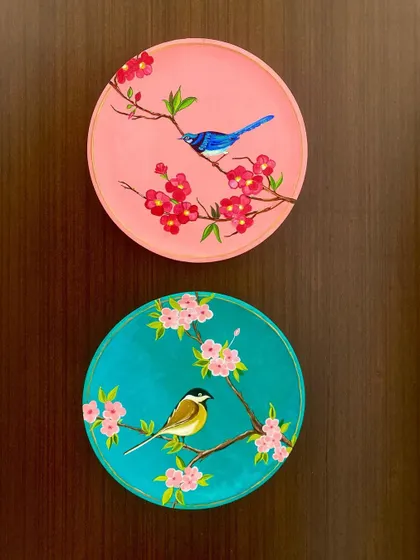 Another arrangement of the pink and blue bird plates, showing how they can be displayed vertically to suit different wall spaces.