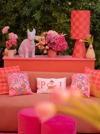 Another angle of the playful lounge, showing the mix of patterns and textures in shades of pink and orange.