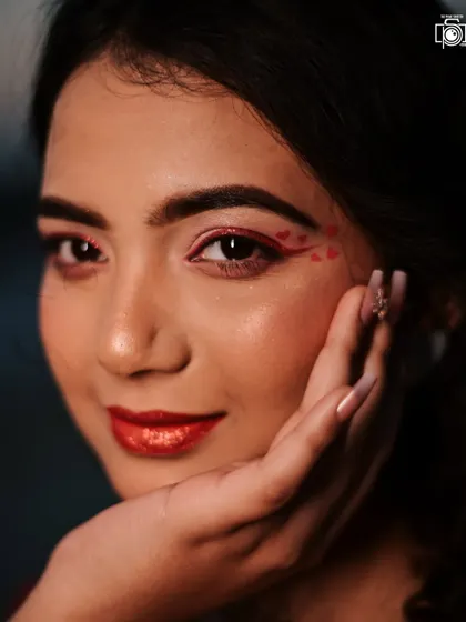 A beautiful beauty shot highlighting the heart-themed makeup and glossy red lips. This type of close-up is essential for showcasing the skill of the makeup artist and capturing a specific theme.
