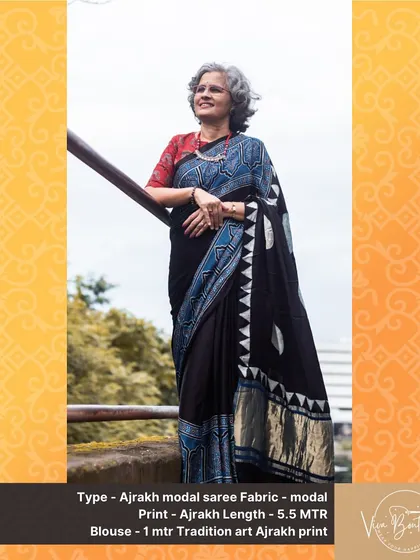 A customer looking elegant in our black Ajrakh modal saree. The intricate blue and white geometric patterns on the pallu add a modern touch to this traditional craft.