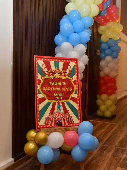 A carnival-themed welcome sign with classic red and white stripes.