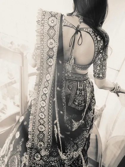 A black and white photo that emphasizes the incredible texture and detail of the multi-colored lehenga. The traditional patterns are just stunning.