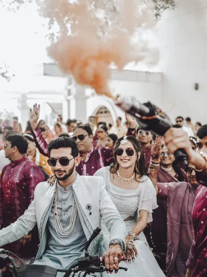 Making a grand entrance on a scooter with color smoke, this shot is full of energy and celebration.