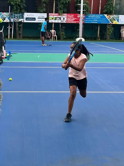 A young athlete practices her volleys at the net. Our drills emphasize quick reactions and precise racket control, essential skills for dominating the front of the court.
