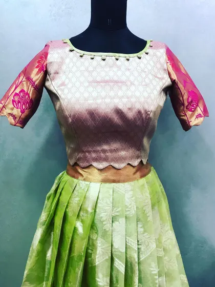 A detailed view of a custom crop top made from a silk saree. I used the saree's border for the sleeves and added delicate piping around the neckline.