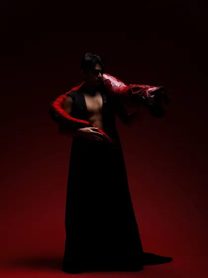 A dramatic, low-light shot of a male model from the "Yume" editorial, with subtle smokey eye makeup enhancing the mood.