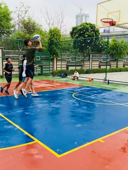 A player goes for a layup, not letting the rain affect their performance.