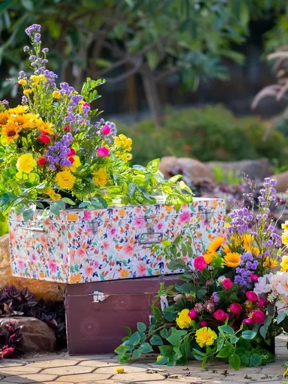 A charming decor detail: custom-printed floral trunks used as pedestals for flower arrangements.