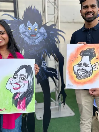A couple posing with their caricatures in front of a character from the anime Death Note. A very cool and thematic event.