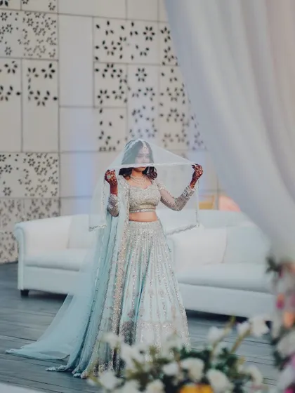 A shy glance from the bride under her veil before her big reveal. A moment of quiet anticipation and beauty.