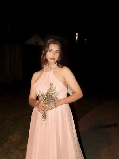 A front-facing pose with the Jardinvue dress and flowers, creating a romantic aesthetic.