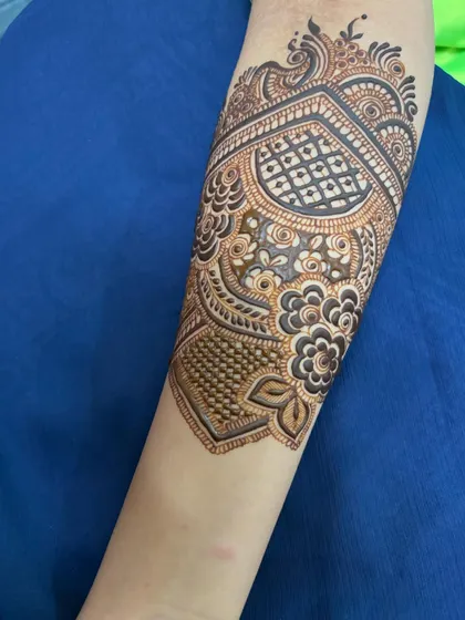 A close-up of the arm band, featuring a heart-shaped pattern filled with delicate netting.