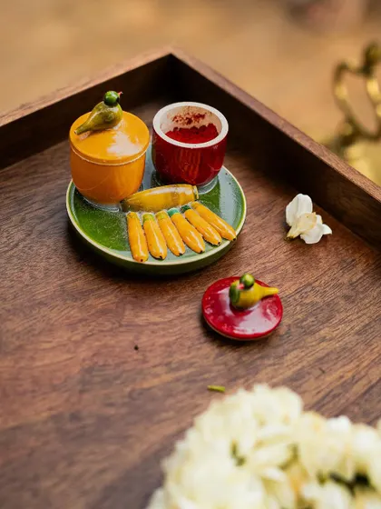 A charming, handcrafted ceramic set for kumkum and turmeric, featuring tiny bird motifs. Sourcing such unique, artisanal pieces is how I ensure that even the most traditional elements of a ceremony feel fresh and personal.