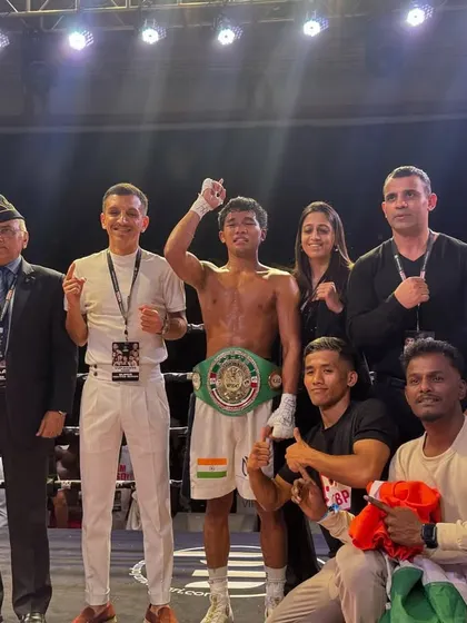 The entire team celebrating the win, from the fighter to the coaches and officials.