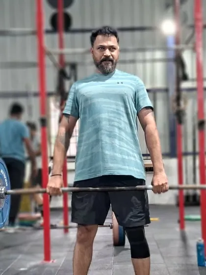 Functional fitness is perfect for busy professionals. This client is performing a deadlift, a fundamental movement that builds full body strength efficiently and prepares you for real life tasks.