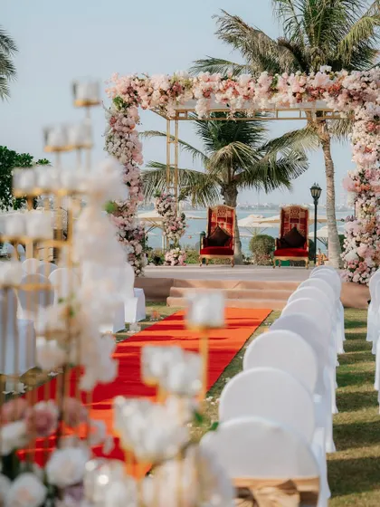 A detailed shot of the beachside mandap in Dubai, ready for the ceremony. The focus on the decor highlights the beauty of the setup.