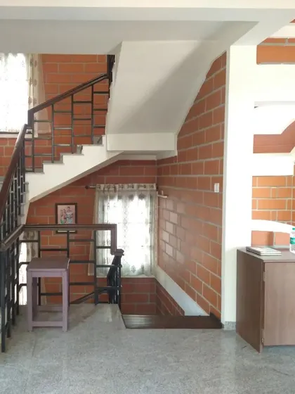 A staircase area with exposed brick walls and arched details, showcasing simple, effective design.