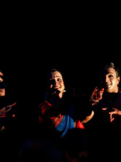A candid moment of interaction between the dancers in 'Naga Mandala'. Even in the darkness, the connection between the performers is palpable.