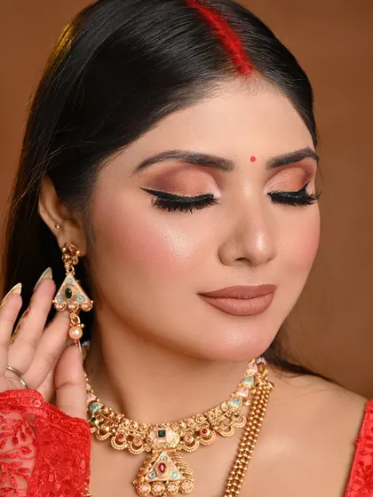 This close-up on the eye makeup shows the soft blending of warm browns and a sharp, clean winged liner, a timeless look for any bride.