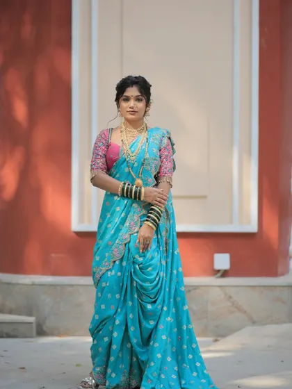 A full-length shot showing the graceful drape of the saree for the Gudi Padwa festival. The styling is traditional from head to toe.