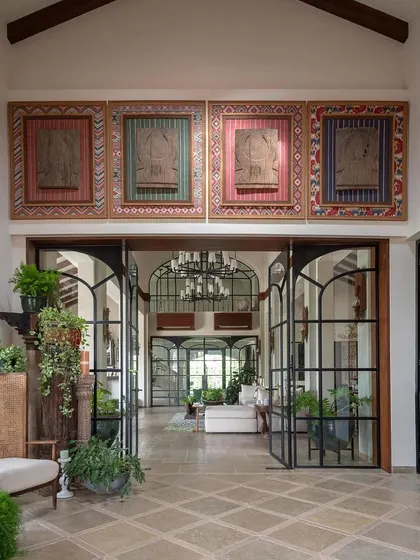The grand entrance of our Alibaug holiday home sets a tone of arrival and wonder. We framed the view with towering glass doors and celebrated Indian craftsmanship with large-scale Naga panels, creating a space that feels both expansive and deeply rooted in cultural heritage.