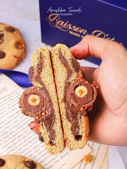 A creative cross-section of a Ferrero Rocher-stuffed cookie, showcasing the surprise inside.