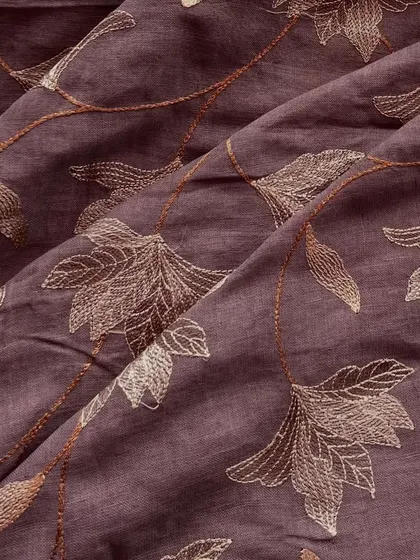 This embroidered linen in a deep mauve shade features delicate floral vine embroidery, offering a chic and effortless look for any day.