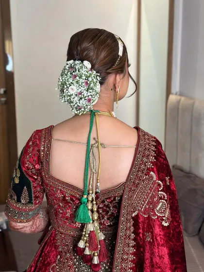 Another angle of the beautiful floral bun, perfect for a bride in a velvet lehenga.