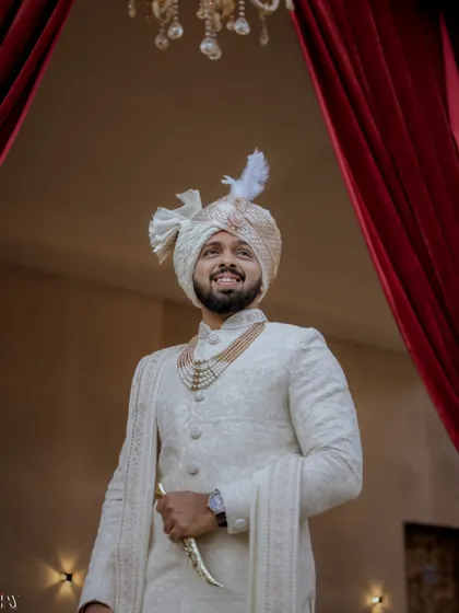 A happy portrait of the groom, looking up with a smile.