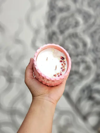 This large, pink diamond-patterned jar is filled with a double-wick soy candle. It's a statement piece that can be repurposed as a beautiful planter or storage pot once the candle is finished.