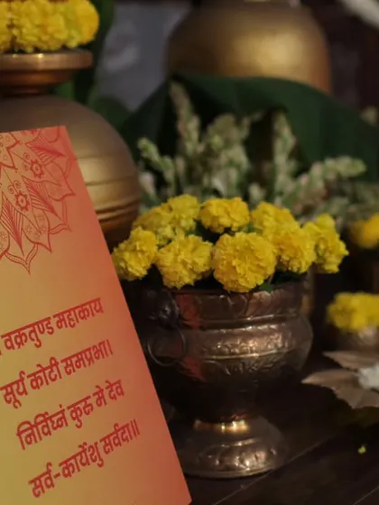 A prayer card placed amongst the decor. Integrating spiritual and traditional elements in a subtle, beautiful way is important for grounding the celebration in its cultural roots.