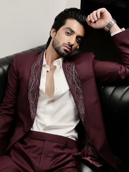 This maroon suit features intricate silver embroidery along the lapels, offering a modern take on formal wear. It’s designed for those who appreciate artistry and want a standout piece for a special occasion.