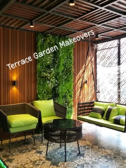 We love creating inviting nooks like this one. The combination of a comfortable swing, modern seating, a lush artificial green wall, and patterned floor tiles turns this patio into a stylish and functional space for quiet afternoons.