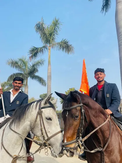 A close-up of two riders and their horses, showing the bond and gentle interaction between them.