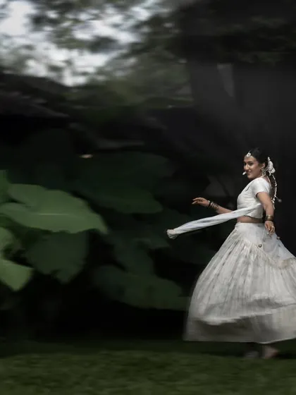 A motion blur shot of the bride twirling in a garden. This technique captures her joyful energy and the beautiful movement of her white lehenga.