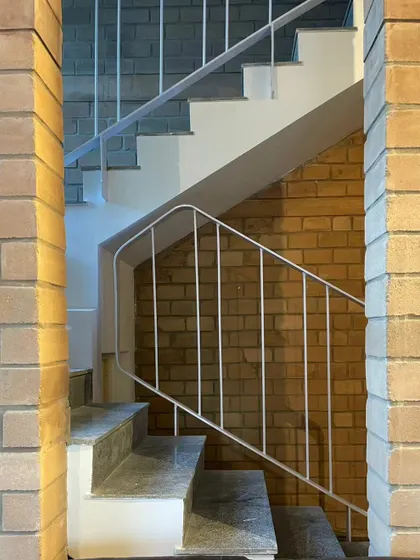 Another angle of the staircase, showing how simple forms and honest materials can create a powerful architectural statement.