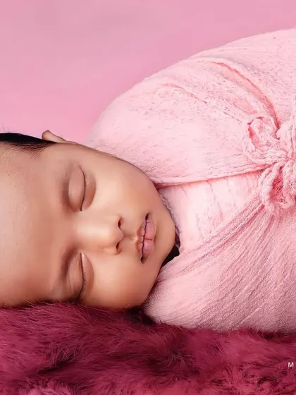 This angle shows the baby's profile, emphasizing their tiny nose and lips.