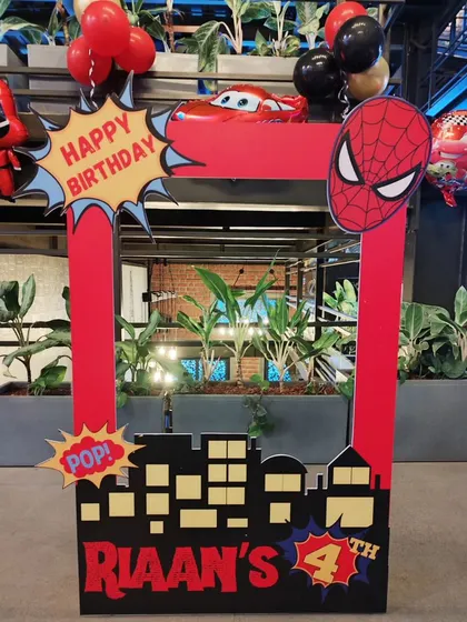 A custom Spiderman-themed photo booth frame, perfect for capturing fun pictures at a superhero party.