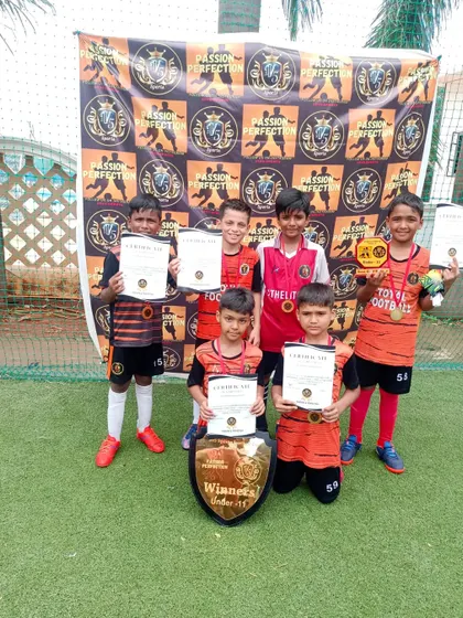The U11 team proudly displaying their certificates after winning the 5v5 Sports Cup.
