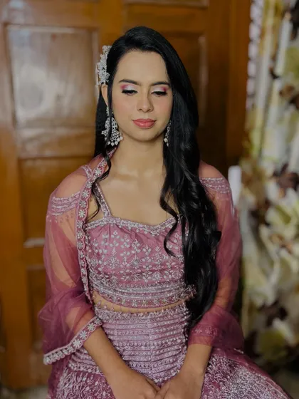 A full view of the client's makeup and hair, with soft waves and a beautiful hair accessory.