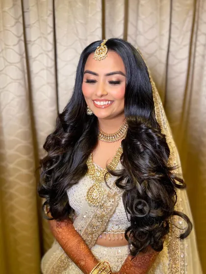 The smile of a happy bride. Bansi's makeup was all about enhancing her natural radiance, with a focus on dewy skin and bright, sparkling eyes.