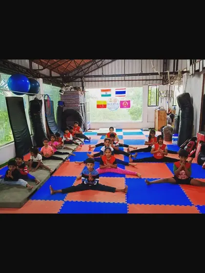 A class works on their middle splits. We dedicate time in every session to flexibility training, which is essential for all gymnastics and martial arts skills.